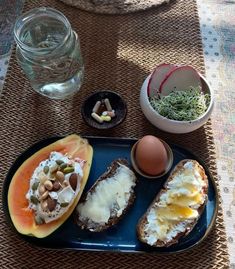 a plate with bread, eggs and vegetables on it