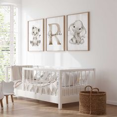 a baby's room with two pictures on the wall and a crib next to it