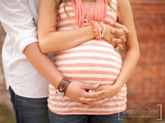 a pregnant woman holding her husband's belly