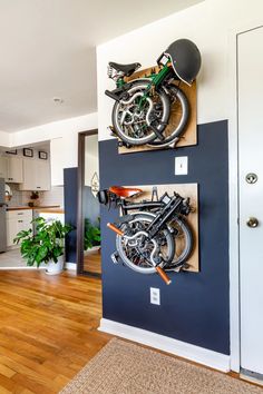 there is a motorcycle mounted to the wall in this kitchen with two bikes on it