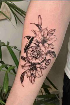 a woman's arm with a clock and flowers on it