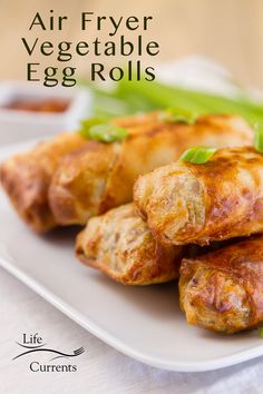 an air fryer vegetable egg rolls on a white plate