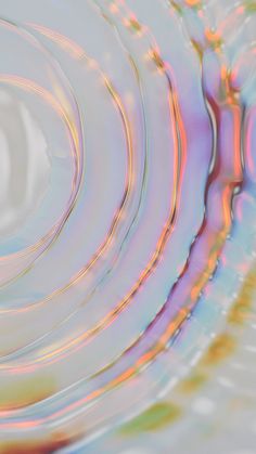 an abstract image of water ripples and circles in blue, pink, yellow and green