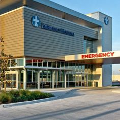 an emergency department building with trees in front