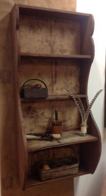 an old wooden shelf with some items on it