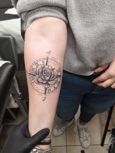 a woman with a rose tattoo on her arm