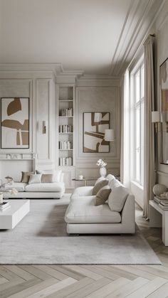 a living room filled with white furniture and lots of bookshelves on the wall