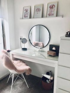 a white desk topped with a mirror and a chair