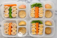 four plastic containers filled with food on top of a marble countertop next to green beans and carrots