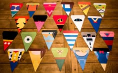 colorful paper pennants are arranged on a wooden table