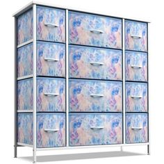 an image of a blue and pink dresser with drawers on the bottom drawer, which is painted in pastel colors