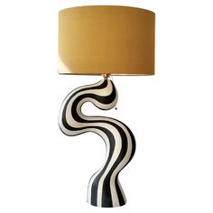 a black and white lamp with a gold shade