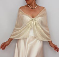 This shiny Metallic Beige Cream Chiffon Wedding Shawl Wrap is the perfect addition to your bridal party's attire. This beautiful bridesmaid dress topper cover-up scarf adds an elegant touch and a hint of glamour to any ensemble, making it an essential accessory for your special day. Crafted from premium-quality, cream silky soft chiffon fabric with shiny gold metallic effect, this wedding shawl wrap boasts a delicate and luxurious texture that drapes gracefully over the shoulders. The metallic c Fitted Wedding Shawl Wrap, Elegant Beige Formal Shawl, Elegant Cream Shawl For Evening, Elegant Satin Wedding Shawl, Elegant Satin Shawl For Wedding, Elegant Silk Wraps For Wedding, Elegant Silk Wedding Wrap, Elegant Silk Wedding Wraps, Cream Silk Shawl For Wedding