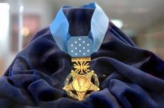 a blue scarf with a gold medal on it