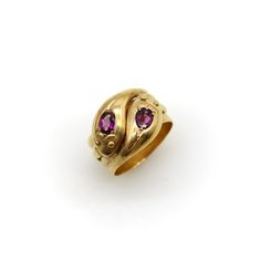 This is part of Chairish’s Fine Jewelry assortment.  This is a classic 9k gold snake ring that has two beautiful rhodolite garnets in the head of each snake. The snake heads interlock   and the garnets are bead set into a mount that are carved to look like tulips. The oval rhodolite garnets are a deep purple pink and have a beautiful fire to their rich, reddish purple hue. The snakes have a cute mouth detail—almost like a smile—and their tails appear on each side of the ring. The wide ring band Tudor Jewelry, Historical Rings, Snake Heads, Medieval Rings, Reddish Purple, Serpent Ring, Ring Pop, Cathy Waterman, Rhaenyra Targaryen