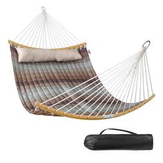 a hammock with a pillow on it and a black bag next to it