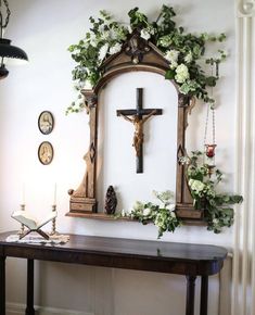 an instagram page with a cross and flowers on the wall next to a table