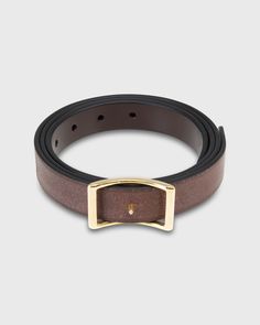 Our kind of reversible belt, made of our faaaavorite English bridle leather. One side is a beautiful, chocolate brown color, while the reverse is lighter and more suede-y. The smooth, darker side can go dressy enough for a suit, while the other one's more casual. If you're traveling, this is the one you need. The conroy buckle — with adjustable sizing, a center prong, and nearly invisible holes — has a beautiful, almost architectural symmetry to it. (And don't sweat the stamp; it gets covered up when you wear it.) Formal Brown Bridle Leather Belt Buckle, Architectural Symmetry, Classic Brown Bridle Leather Belt, Luxury Brown Belts With Brass Hardware, Luxury Adjustable Brown Belt, Brown Suade Belts, Chocolate Brown Color, English Bridle, Beautiful Chocolate