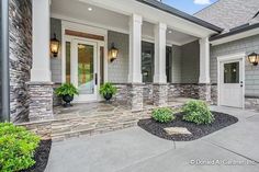 the front entrance of a house with stone and white trim