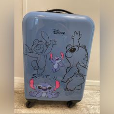 a blue suitcase with cartoon characters on it