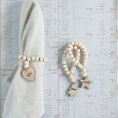 a white tie and some wooden beads on a table