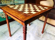 a wooden table with chess pieces on it