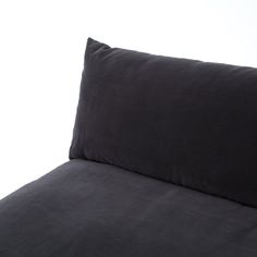 a black pillow sitting on top of a bed