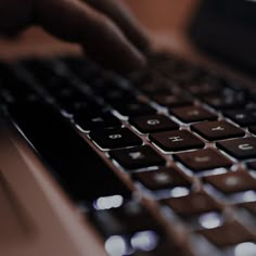 a person typing on a laptop computer keyboard