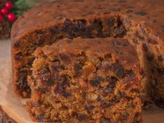 a close up of a cake on a wooden surface with one slice cut out and the other half eaten