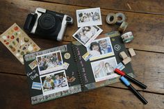 an open photo album sitting on top of a wooden table next to tape and scissors