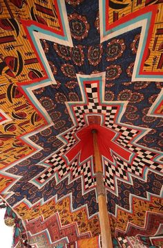 the inside of an umbrella that is decorated with colorful patterns and designs on it's sides