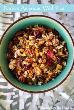 a bowl filled with rice and nuts on top of a table