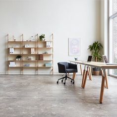 an empty room with two chairs and a table