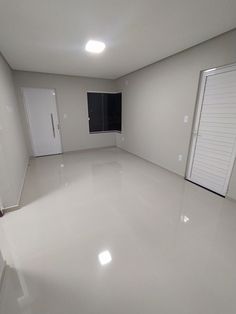 an empty room with white walls and doors