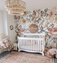 a baby's room with floral wallpaper and white crib