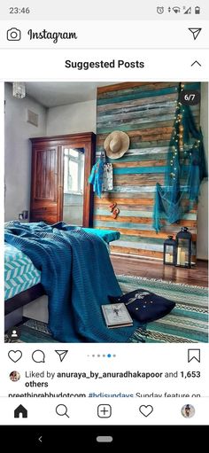 a bed room with a neatly made bed next to a wooden wall covered in blue blankets