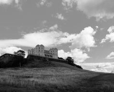 an old castle sitting on top of a hill