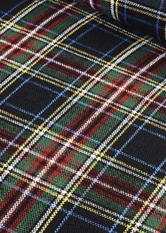 a plaid fabric with blue, green and red colors on it's side is shown