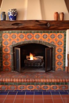 a fireplace with an orange and blue tile surround