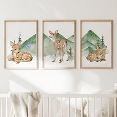 two deer prints hanging on the wall above a crib