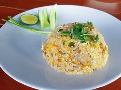 a white plate topped with rice and veggies