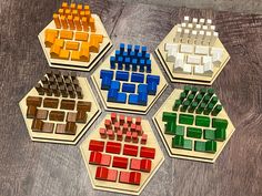 six wooden blocks arranged in the shape of hexagons on top of a table