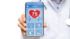 a doctor holding up a smart phone with the number 75 on it's screen