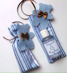 two blue and white striped key chains with flowers on them, one has a bottle of toothpaste in the shape of a flower