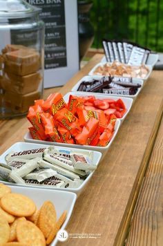 several trays of snacks are lined up on a table