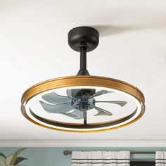 a ceiling fan that is hanging from the ceiling