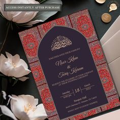 an ornate wedding card with arabic calligraphy on it and white flowers in the background