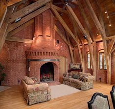 a living room filled with furniture and a fire place in the middle of a building