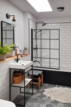 A modern bathroom with white subway tiles, black industrial fixtures, and a statement Industville wall light illuminating the sink area. Lights Interior Design, Geometric Tile Floor, Monochrome Bathroom, Lights Interior, Bathroom Lights