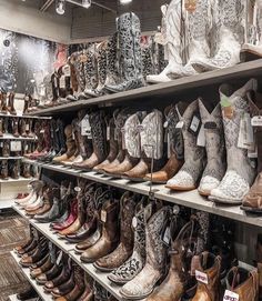 many pairs of cowboy boots are on display